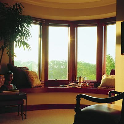 Living room with brown 400 Series bay windows