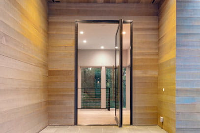view of wooden exterior entryway with andersen pivot door